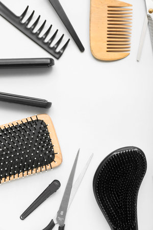 Frame made of hairdressing accessories on white background