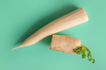 Fresh daikon radish on turquoise backgroundの写真素材