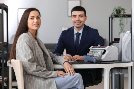 Male bank manager working with client in officeの写真素材