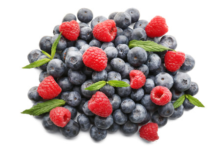 Ripe raspberry and blueberry on white background