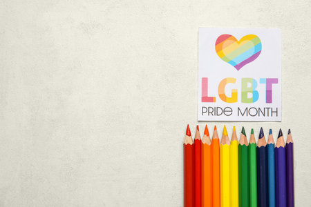 Card with text LGBTQ PRIDE MONTH and pencils on white backgroundの写真素材
