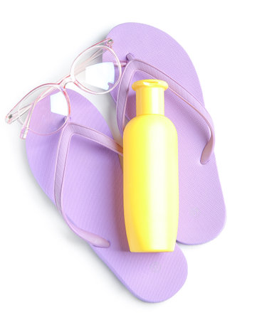 Bottle of sunscreen cream with sunglasses and flip flops isolated on white backgroundの写真素材