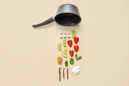 Saucepan and ingredients for preparing strawberry compote on beige backgroundの写真素材