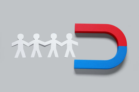 Magnet attracting group of employees on white background. Recruitment conceptの写真素材