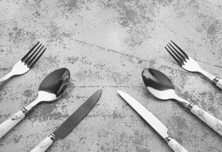 Silver cutlery on gray grunge backgroundの写真素材