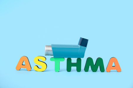 Word ASTHMA and inhaler on blue backgroundの写真素材