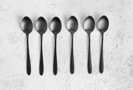 Stainless steel spoons on white backgroundの写真素材