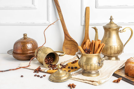 Composition with vintage tableware, cinnamon sticks and coffee beans on light tableの写真素材