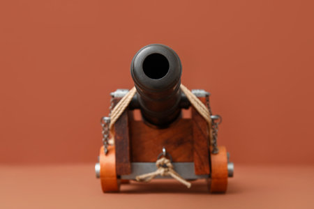 Toy model of cannon on brown backgroundの写真素材