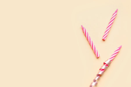 Pink birthday candles on beige backgroundの写真素材