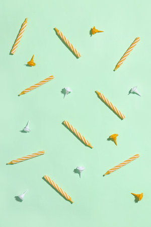 Yellow birthday candles on green backgroundの写真素材