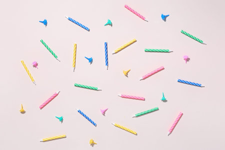 Colorful birthday candles on pink background