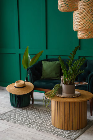 Interior of living room with coffee table, pouf and sofa