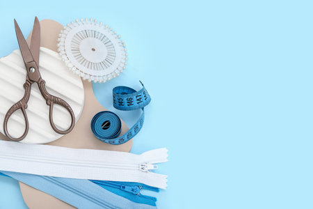 Podiums with tailor's supplies on blue background