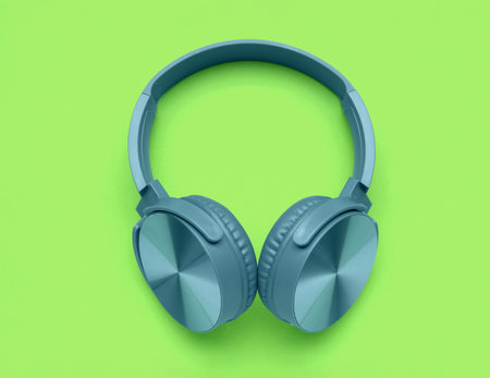 Modern blue headphones on green backgroundの写真素材