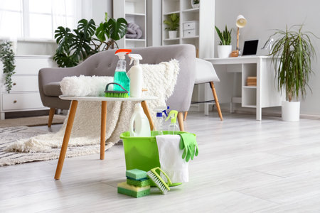 Table with cleaning supplies in the living roomの写真素材