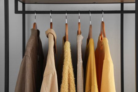 Rack with stylish clothes near light wall, closeupの写真素材