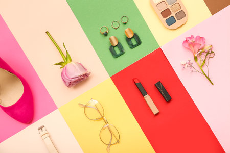 Composition with stylish female accessories, cosmetics and flowers on color backgroundの写真素材