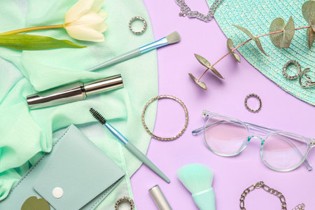 Composition with stylish female accessories and cosmetics on lilac backgroundの写真素材