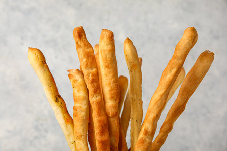Tasty Italian Grissini on light background, closeup