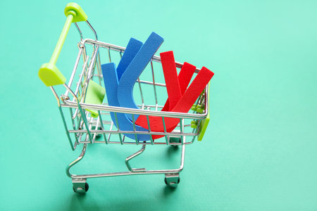 Mini trolley with magnets on green backgroundの写真素材