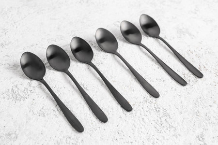 Stainless steel spoons on white backgroundの写真素材