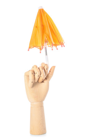 Creative composition with wooden hand and mini umbrella on white backgroundの写真素材