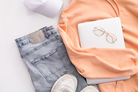 Stylish clothes with accessories, sneakers and laptop on white background, closeupの写真素材