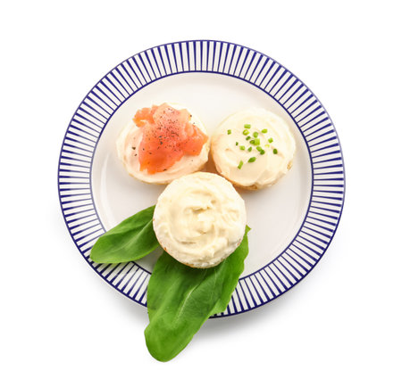 Plate of tasty croutons with cream cheese and fish on white backgroundの写真素材