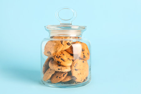 Jar with cookies on blue backgroundの写真素材