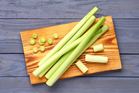 Board with fresh leeks on blue wooden backgroundの写真素材