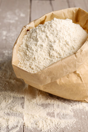 Paper bag with wheat flour on gray wooden backgroundの写真素材