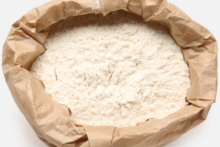 Paper bag with wheat flour on white backgroundの写真素材