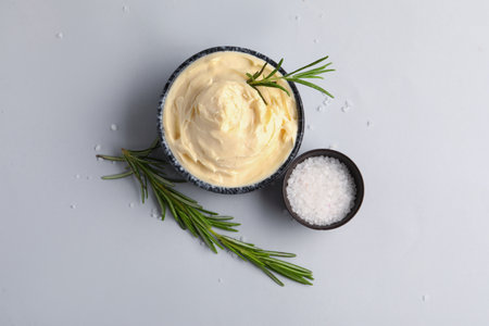 Bowl with tasty cream cheese on gray backgroundの写真素材