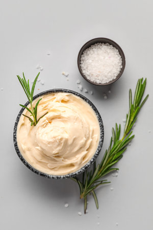 Bowl with tasty cream cheese on gray backgroundの写真素材
