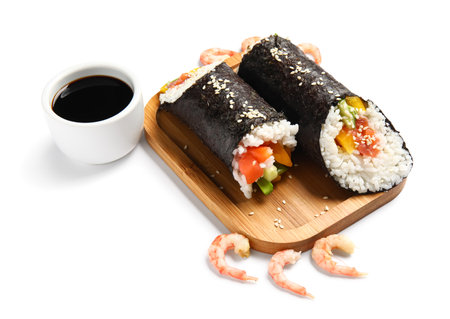 Wooden board with tasty sushi rolls and soy sauce on white backgroundの写真素材