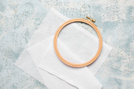Wooden embroidery hoop with canvas on grunge blue backgroundの写真素材
