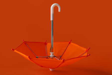 Mini umbrella on red backgroundの写真素材
