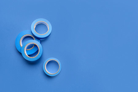 Adhesive tape rolls on blue backgroundの写真素材