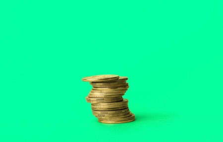 stack of coins on green backgroundの写真素材
