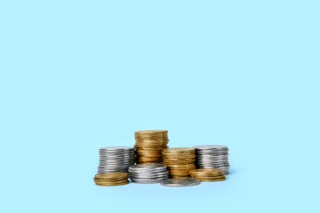 Stacks of coins on blue background