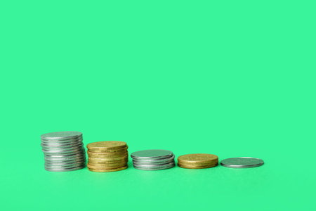Stacks of coins on green background