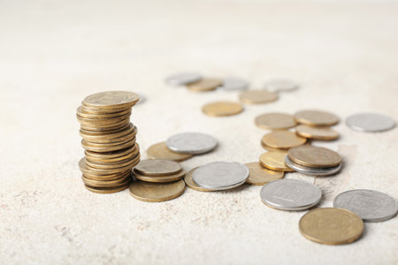 Stack of coins on beige grunge tableの写真素材
