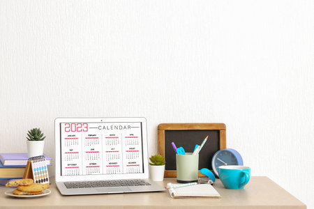 Modern laptop with calendar at workplaceの写真素材