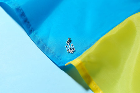 Pendant with Ukrainian coat of arms and flag on blue background, closeupの写真素材