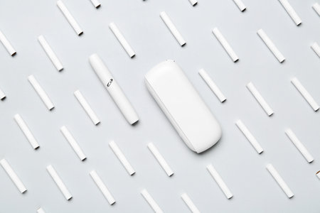 Modern electronic cigar and many sticks on gray backgroundの写真素材
