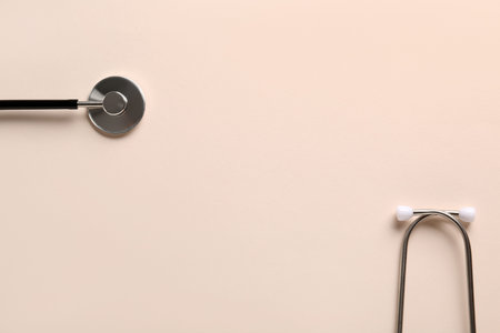 Modern stethoscope on light background