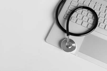 Stethoscope and laptop on light background, top viewの写真素材