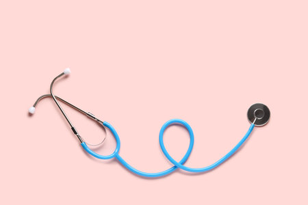 Modern stethoscope on pink backgroundの写真素材