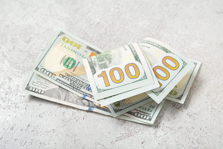 One hundred dollar banknotes on gray grunge background